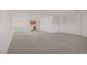 Spacious bonus room with modern lighting fixtures and partial kitchen area at 7255 Bold Rock Ave, Las Vegas, NV 89113