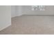 Open bonus room featuring neutral carpeting and natural light from two windows at 7255 Bold Rock Ave, Las Vegas, NV 89113