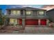 Elegant two-story home with a three-car garage, stone accents, and manicured landscaping, perfect for Gathering living at 7255 Bold Rock Ave, Las Vegas, NV 89113