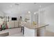 Open concept kitchen and living area with island seating and modern lighting at 7255 Bold Rock Ave, Las Vegas, NV 89113