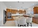 Modern kitchen with stainless steel appliances, granite countertops, and an island with seating at 7255 Bold Rock Ave, Las Vegas, NV 89113