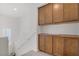 Upstairs landing with brown cabinets and a window overlooking the stairs at 7255 Bold Rock Ave, Las Vegas, NV 89113