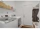 Functional laundry room with modern washer and dryer and ample storage space at 7255 Bold Rock Ave, Las Vegas, NV 89113
