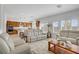 Open-concept living space featuring modern furnishings and an adjacent kitchen area at 7255 Bold Rock Ave, Las Vegas, NV 89113