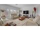 Bright living room with plush seating, large windows, and neutral decor at 7255 Bold Rock Ave, Las Vegas, NV 89113
