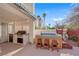 Outdoor kitchen and hot tub with stools offer a fantastic space for grilling and unwinding in style at 7333 Painted Shadows Way, Las Vegas, NV 89149