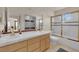 Bright bathroom featuring dual vanities, tile floors, and a glass enclosed shower at 7333 Painted Shadows Way, Las Vegas, NV 89149