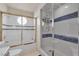 Modern bathroom with a tub/shower and separate glass enclosed shower at 7333 Painted Shadows Way, Las Vegas, NV 89149