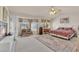 Spacious primary bedroom boasts a fireplace, a sitting area, and a ceiling fan at 7333 Painted Shadows Way, Las Vegas, NV 89149