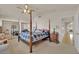 Bedroom featuring a 4-poster bed, mirrored closet doors, and an ensuite bathroom at 7333 Painted Shadows Way, Las Vegas, NV 89149