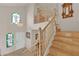 Staircase with wooden railing and stained glass windows leading to the second floor at 7333 Painted Shadows Way, Las Vegas, NV 89149