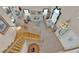 Staircase with wooden railing leading to the second floor and view of the formal living room at 7333 Painted Shadows Way, Las Vegas, NV 89149