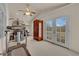 Bright exercise room featuring mirrored closet doors and access to the outdoors at 7333 Painted Shadows Way, Las Vegas, NV 89149