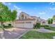 Stunning two-story home with a three-car garage, tiled roof, desert landscaping, and brick paved driveway at 7333 Painted Shadows Way, Las Vegas, NV 89149