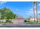 Inviting two-story home with a three car garage, lush landscaping, and a well-manicured front yard at 7333 Painted Shadows Way, Las Vegas, NV 89149