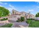 Charming two-story home with a three-car garage, well-maintained lawn, desert landscaping, and brick paved driveway at 7333 Painted Shadows Way, Las Vegas, NV 89149