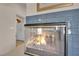 Close up of fireplace with blue tile surround and glass enclosure at 7333 Painted Shadows Way, Las Vegas, NV 89149