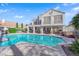 Backyard with a private pool, covered patio, outdoor seating area, and lush, mature landscaping at 7333 Painted Shadows Way, Las Vegas, NV 89149