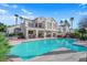 Inviting backyard pool area with a covered patio, outdoor seating, built-in barbecue, and well-manicured landscaping at 7333 Painted Shadows Way, Las Vegas, NV 89149
