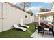 Outdoor living space featuring a patio, sun loungers, and lush artificial grass at 7925 Limbwood Ct, Las Vegas, NV 89131