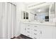Bright bathroom featuring dual sinks, bright cabinetry, and neutral paint at 7925 Limbwood Ct, Las Vegas, NV 89131