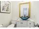 Stylish powder room with a unique blue glass bowl sink and marble countertop at 7925 Limbwood Ct, Las Vegas, NV 89131