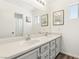 Bright bathroom with double sinks, modern fixtures, and ample counter space at 7925 Limbwood Ct, Las Vegas, NV 89131