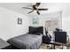 Cozy bedroom features a ceiling fan, a window with natural light, and a relaxing workspace at 7925 Limbwood Ct, Las Vegas, NV 89131