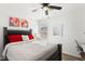 Bright bedroom with a ceiling fan, a large window, and art decorations on the wall at 7925 Limbwood Ct, Las Vegas, NV 89131