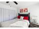 Well-lit bedroom featuring a comfortable bed, modern decor, and a large window at 7925 Limbwood Ct, Las Vegas, NV 89131