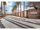 Paloma at Elkhorn Springs community entrance lined with mature palm trees and a stone sign at 7925 Limbwood Ct, Las Vegas, NV 89131