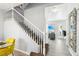 Entryway features a staircase with white railing, leading to an upstairs area and an adjacent living space at 7925 Limbwood Ct, Las Vegas, NV 89131