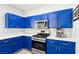 Kitchen showcases blue cabinetry, stainless steel appliances, and marble countertops, with efficient and stylish design at 7925 Limbwood Ct, Las Vegas, NV 89131