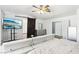 This is a staged main bedroom featuring a modern entertainment center, barn door, and bright paint at 7925 Limbwood Ct, Las Vegas, NV 89131