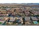 Community aerial view displaying many single Gathering homes, street layout, and desert landscaping with mountain backdrop at 8298 W Agate Ave, Las Vegas, NV 89113