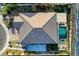 Aerial view of home showcasing a tiled roof, pool, spa, covered patio, backyard space, and desert landscaping at 8298 W Agate Ave, Las Vegas, NV 89113