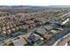 Community aerial view exhibiting numerous homes with pools, street design, desert landscaping, and mountain views at 8298 W Agate Ave, Las Vegas, NV 89113