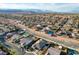 Expansive aerial view of a desert community featuring well-maintained homes with mountain views at 8298 W Agate Ave, Las Vegas, NV 89113