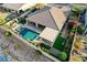 Overhead shot showing a home with a pool, hot tub, covered patio, and green turf in a private backyard at 8298 W Agate Ave, Las Vegas, NV 89113
