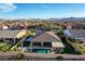 Impressive backyard showcasing a shimmering pool, hot tub, covered patio, and manicured landscaping for relaxation at 8298 W Agate Ave, Las Vegas, NV 89113