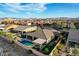Beautiful backyard with a refreshing pool, hot tub, covered patio, and lush landscaping, perfect for entertaining at 8298 W Agate Ave, Las Vegas, NV 89113