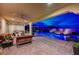 Outdoor living area featuring a swimming pool, covered patio, stylish seating, and beautiful landscaping at 8298 W Agate Ave, Las Vegas, NV 89113