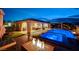 Inviting backyard with a pool, spa, fire pit, covered patio, and ample seating space, ideal for outdoor living at 8298 W Agate Ave, Las Vegas, NV 89113