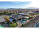 Stunning backyard with a sparkling pool, hot tub, covered patio, and well-maintained landscaping for outdoor enjoyment at 8298 W Agate Ave, Las Vegas, NV 89113