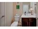 Well-lit half bathroom with dark wood cabinets, a sink with a quartz counter, and a modern faucet at 8298 W Agate Ave, Las Vegas, NV 89113