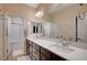 Bright bathroom features dual sinks with a shower-tub combination at 8298 W Agate Ave, Las Vegas, NV 89113