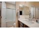 Bright bathroom featuring a vanity with a white countertop and a shower-tub combination at 8298 W Agate Ave, Las Vegas, NV 89113