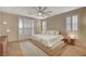 Bright bedroom features wood floors, plantation shutters, and a stylish ceiling fan, creating a cozy retreat at 8298 W Agate Ave, Las Vegas, NV 89113