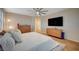 Bright bedroom boasts light wood floors, plantation shutters, and a modern ceiling fan, creating a serene space at 8298 W Agate Ave, Las Vegas, NV 89113