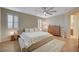 Elegant bedroom showcases light wood floors, plantation shutters, and a ceiling fan, providing a relaxing atmosphere at 8298 W Agate Ave, Las Vegas, NV 89113